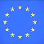 Circle of twelve yellow stars on a blue background representing the EU flag.