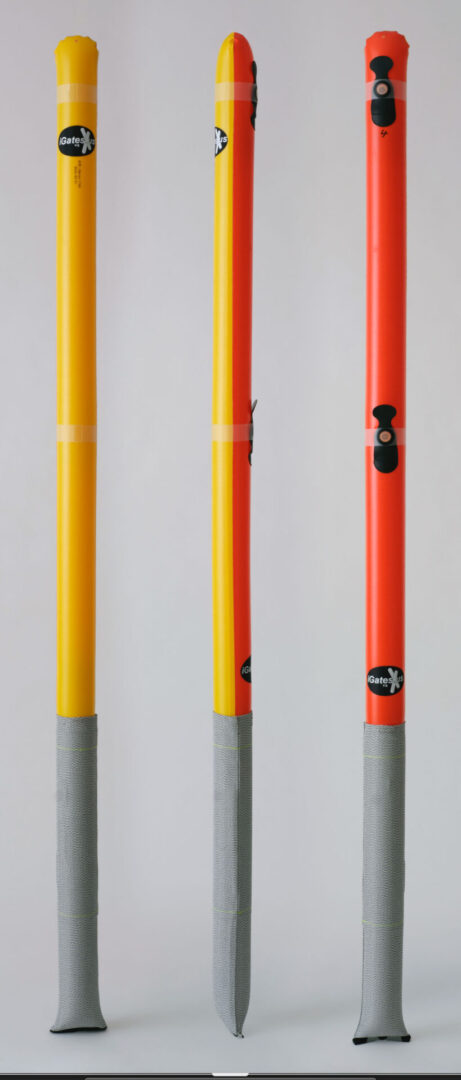 Three colorful poles with gray bases against a plain white background.
