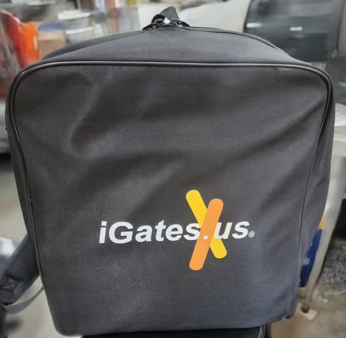 Black bag with 'iGates us.' logo and orange X design.