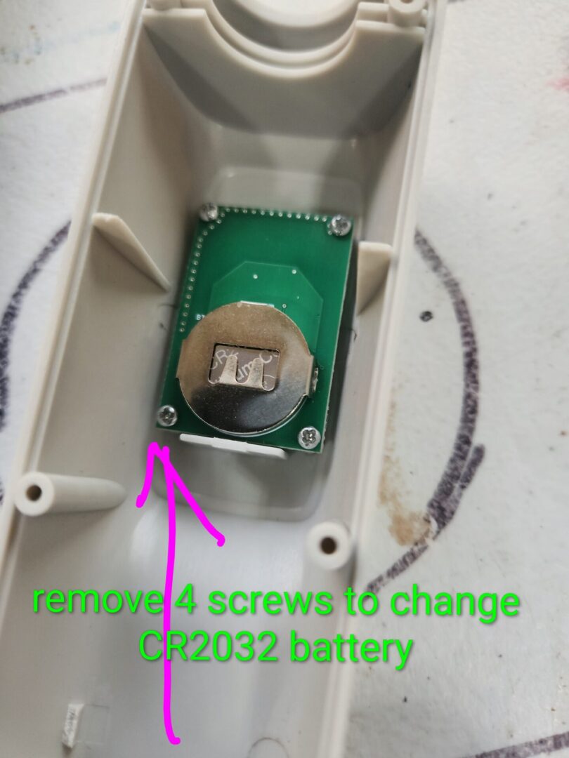 Battery compartment with instructions to remove screws for replacement.